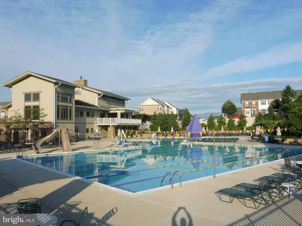 a view of a swimming pool with outdoor seating