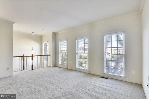 a view of an empty room with windows