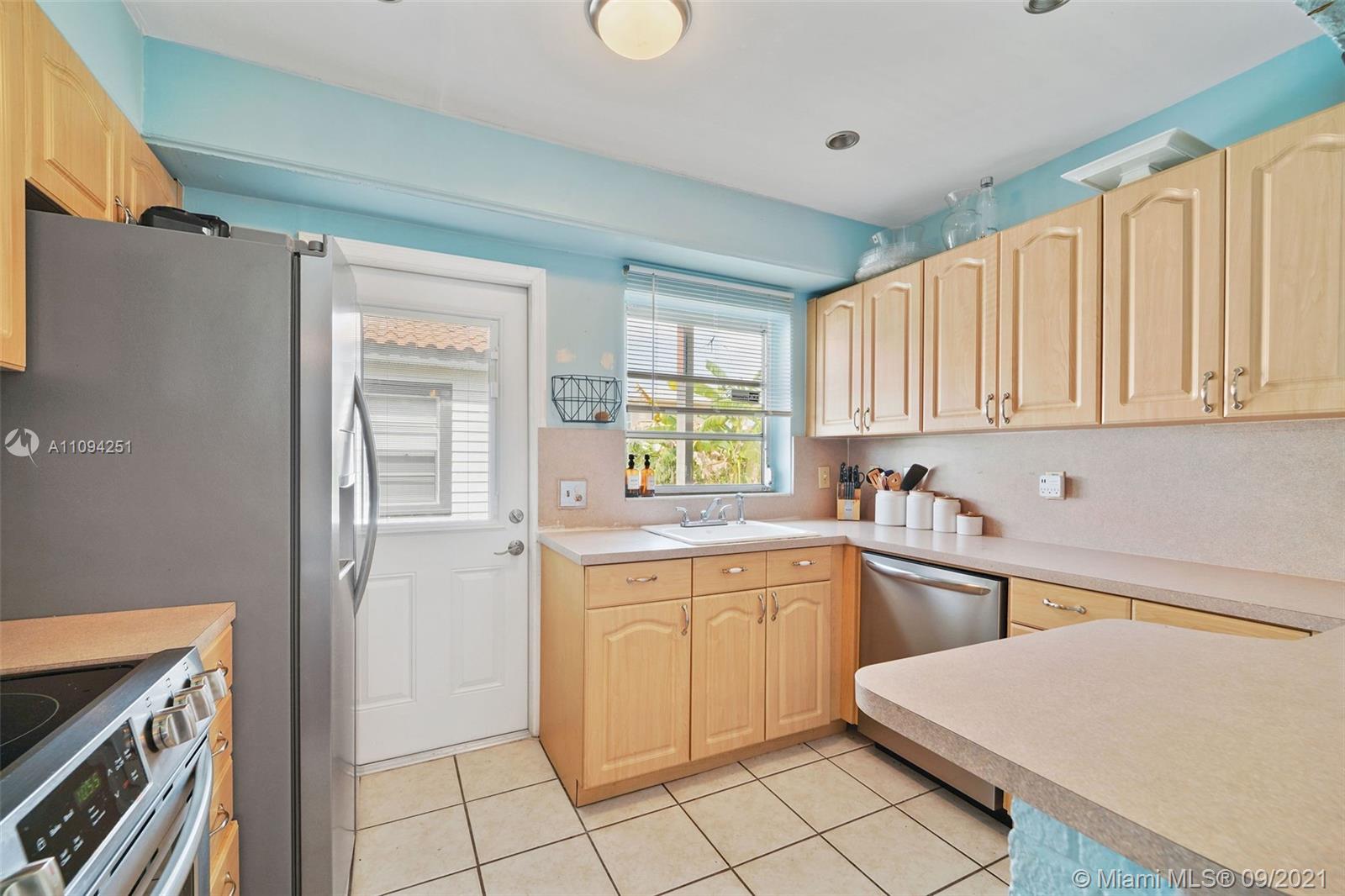 1431 Southwest 20th Street Miami, FL 33145 - Photo 11 of 32 a kitchen with a sink cabinets and window