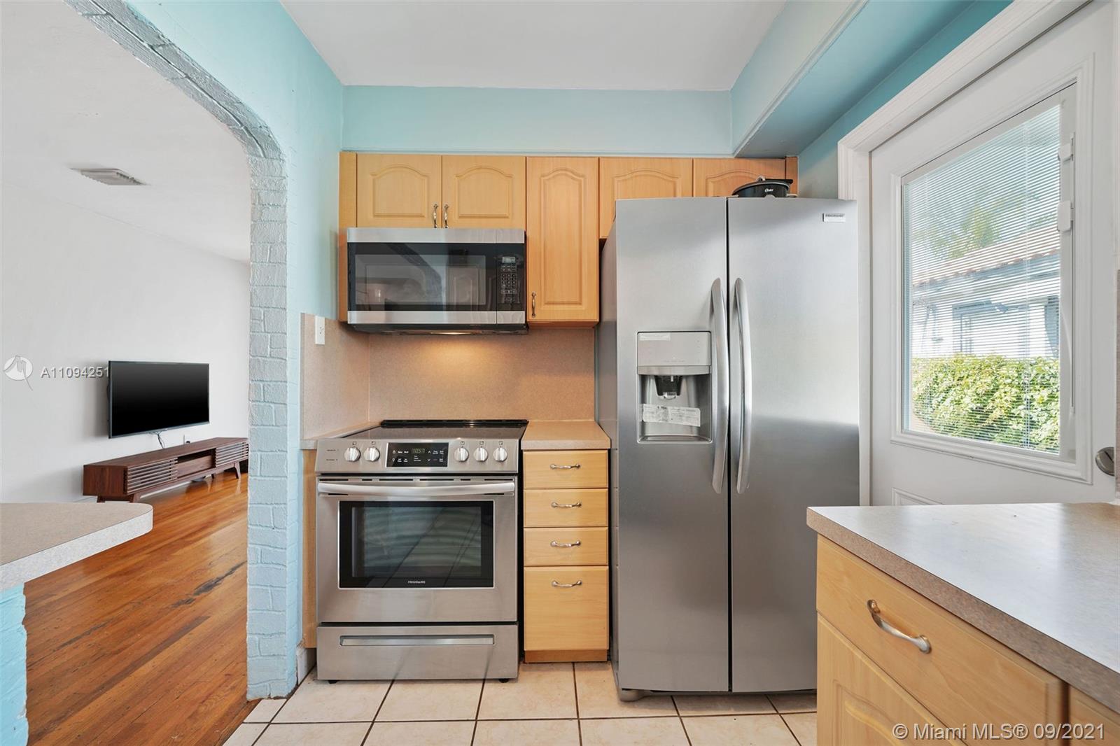 1431 Southwest 20th Street Miami, FL 33145 - Photo 12 of 32 a kitchen with stainless steel appliances granite countertop a refrigerator stove and microwave