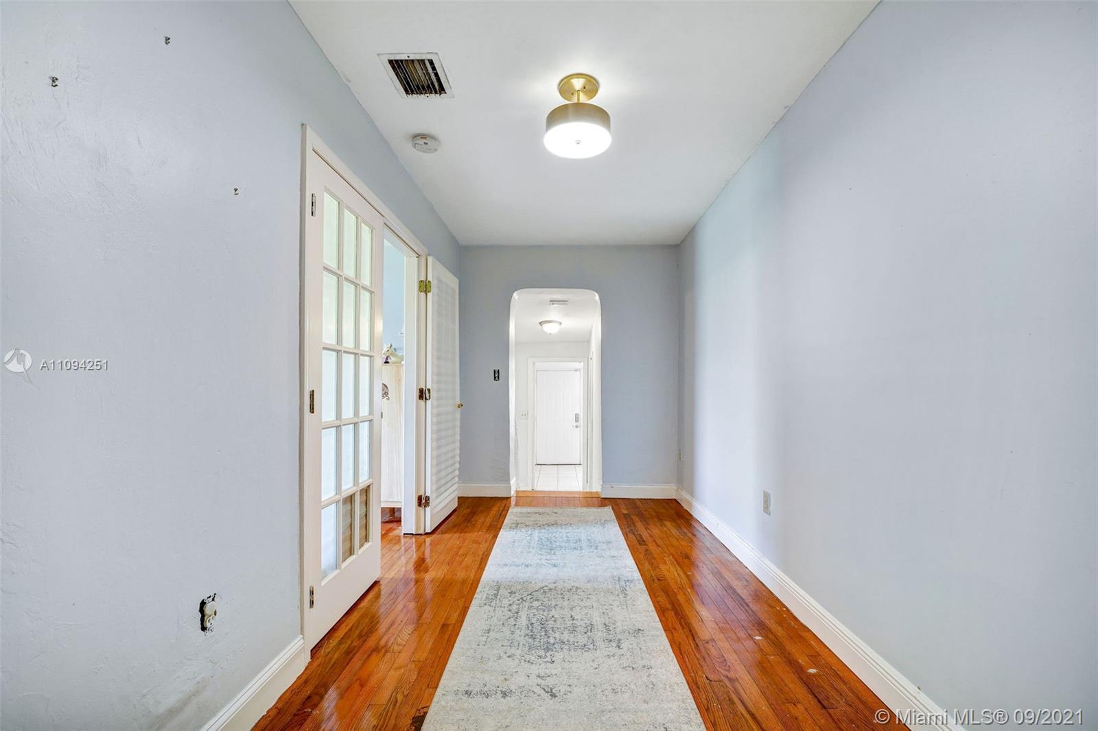 1431 Southwest 20th Street Miami, FL 33145 - Photo 13 of 32 a view of a hallway with wooden floor and closet