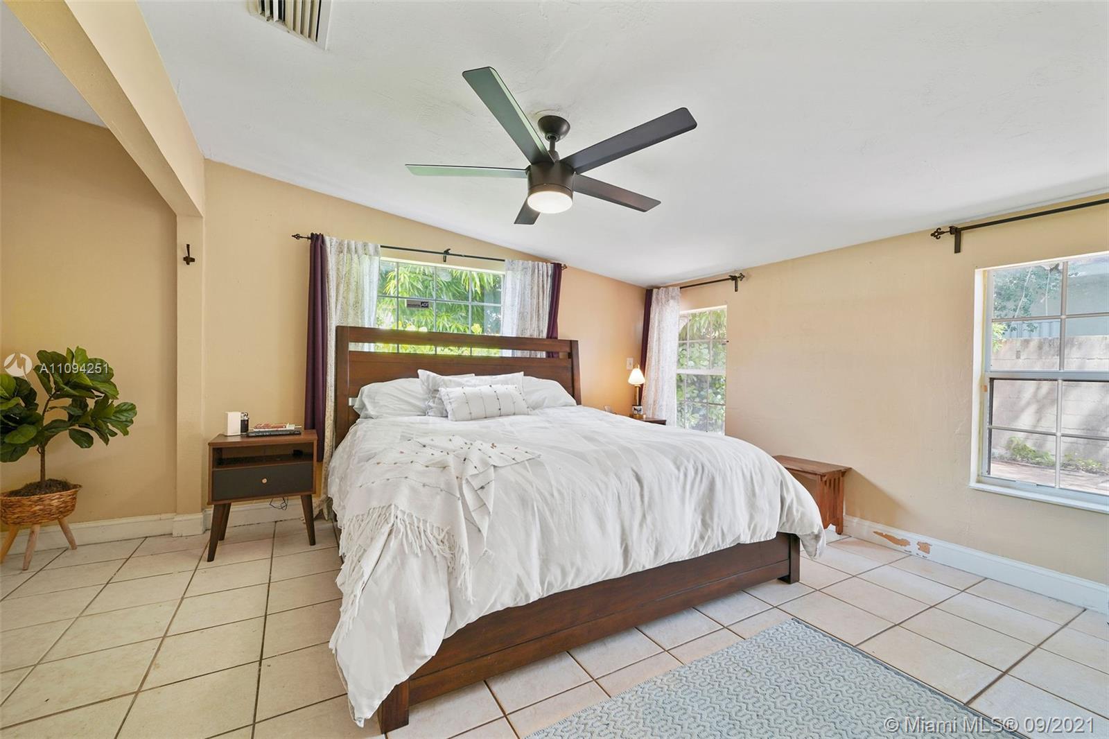 1431 Southwest 20th Street Miami, FL 33145 - Photo 15 of 32 a bed sitting in a spacious bedroom next to a window
