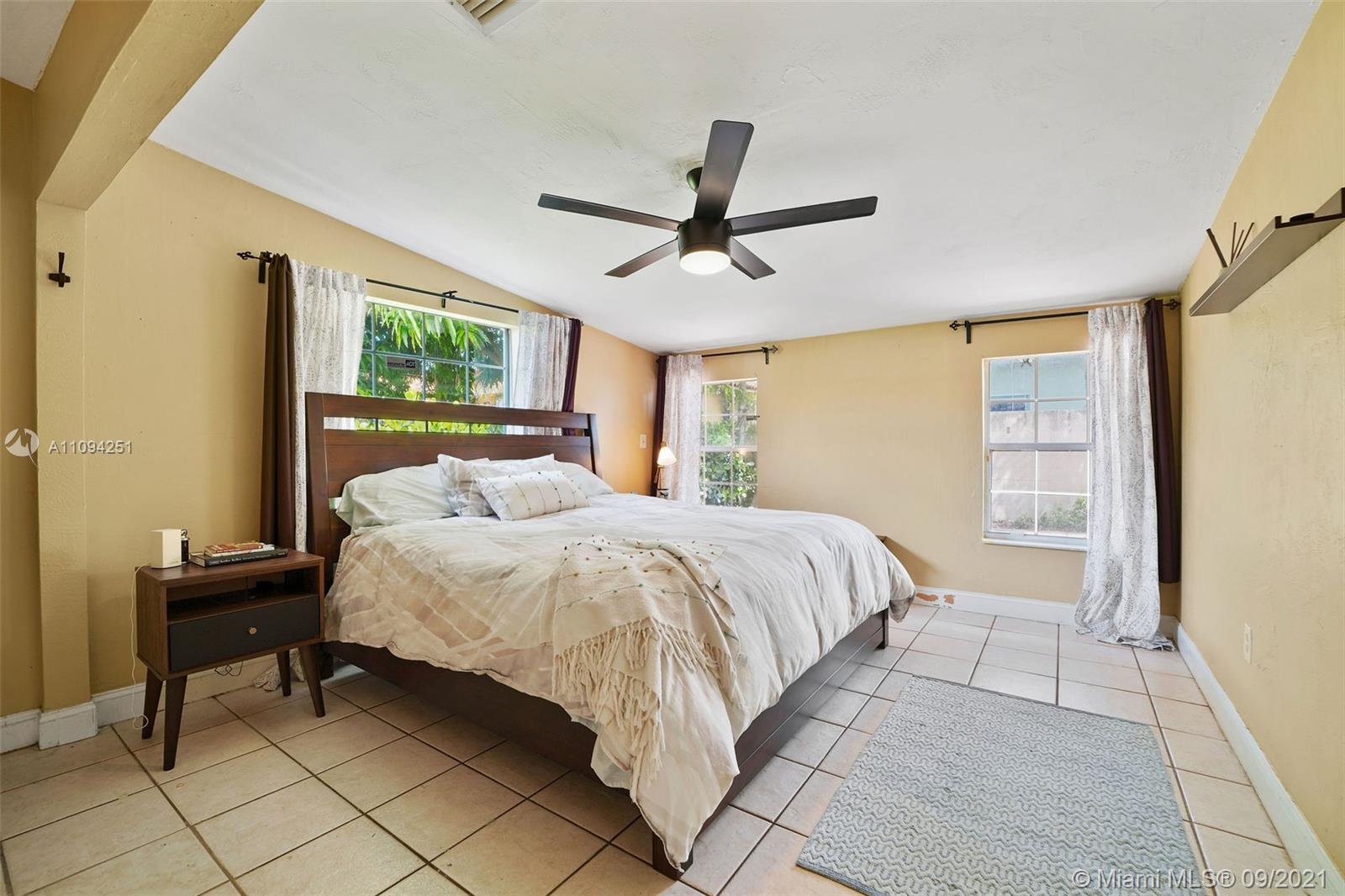 1431 Southwest 20th Street Miami, FL 33145 - Photo 16 of 32 a bedroom with a bed and a window
