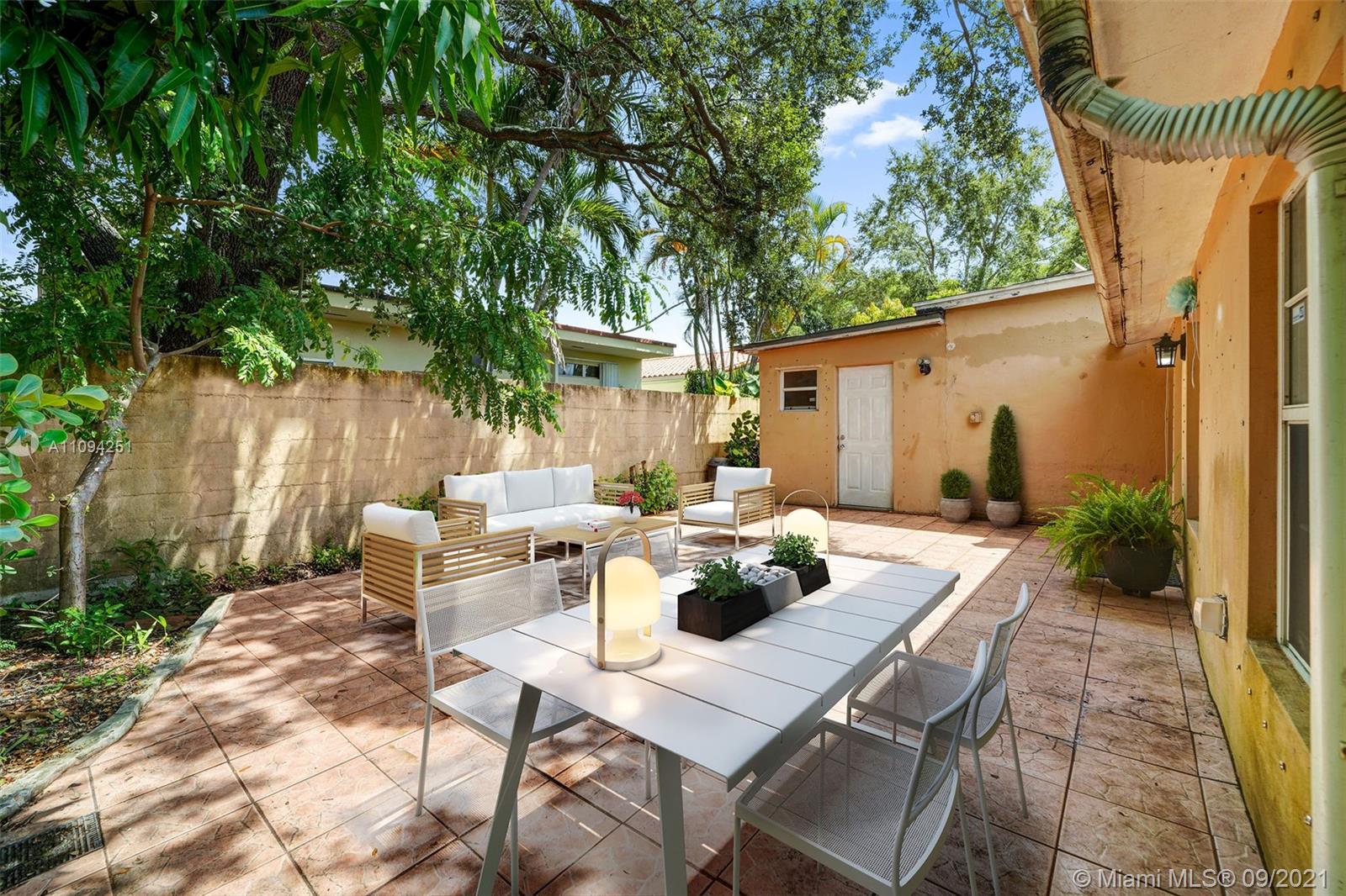 1431 Southwest 20th Street Miami, FL 33145 - Photo 21 of 32 a view of a patio with table and chairs and potted plants