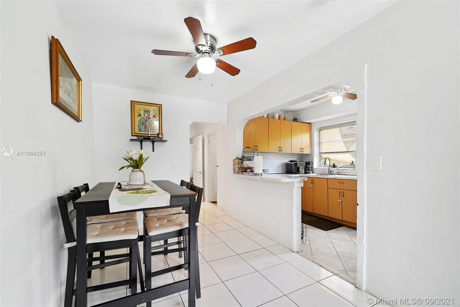 1431 Southwest 20th Street Miami, FL 33145 - Photo 26 of 32 a view of a dining room with furniture and a chandelier fan