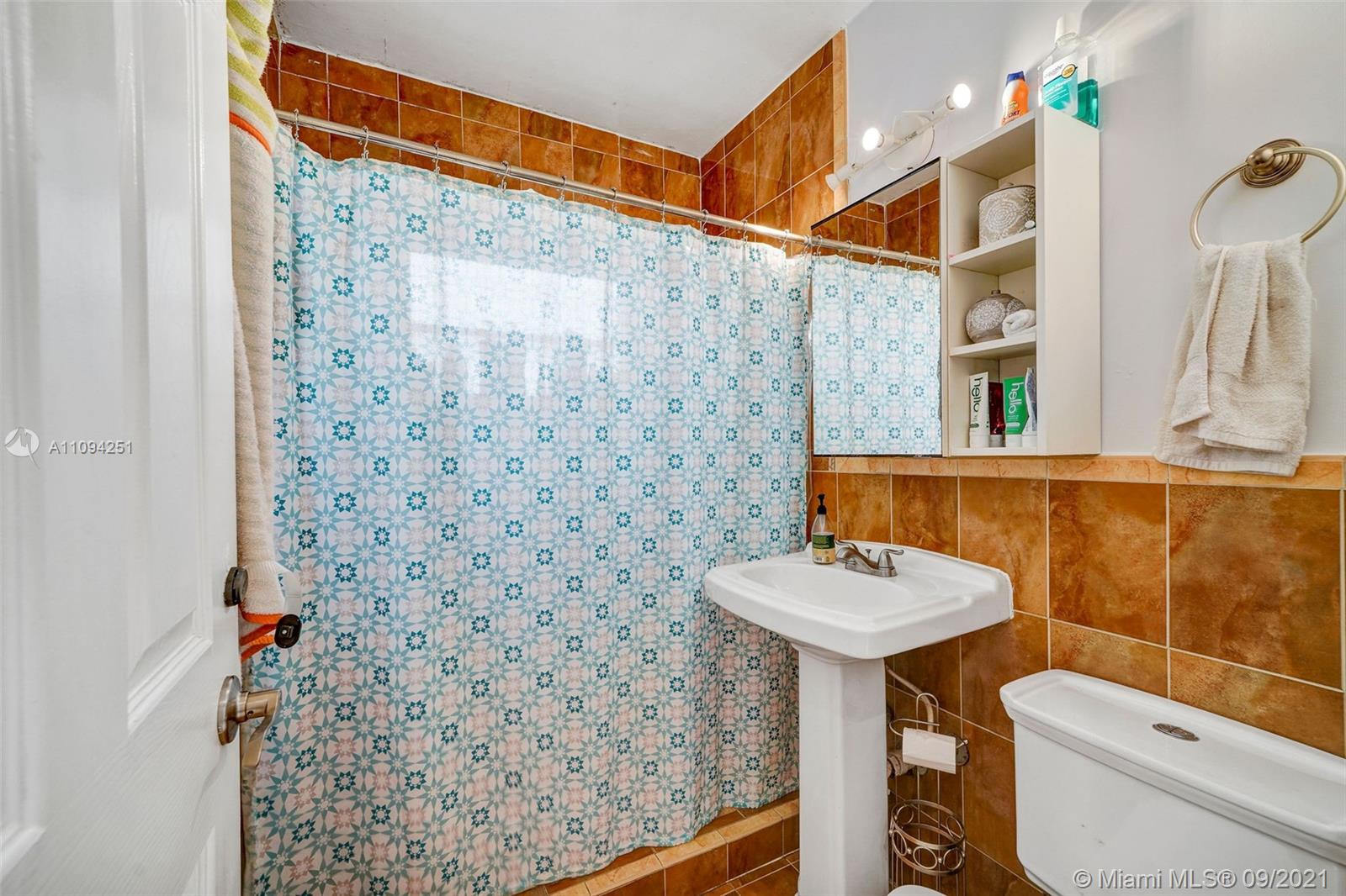 1431 Southwest 20th Street Miami, FL 33145 - Photo 29 of 32 a bathroom with a sink a toilet and shower curtain