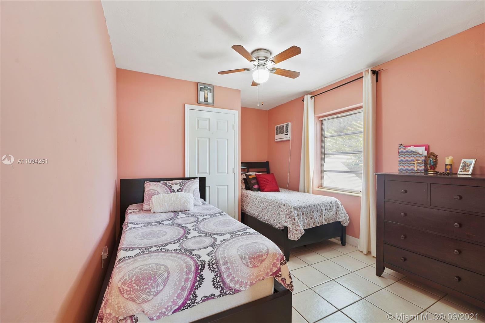 1431 Southwest 20th Street Miami, FL 33145 - Photo 30 of 32 a bedroom with two beds and a chandelier