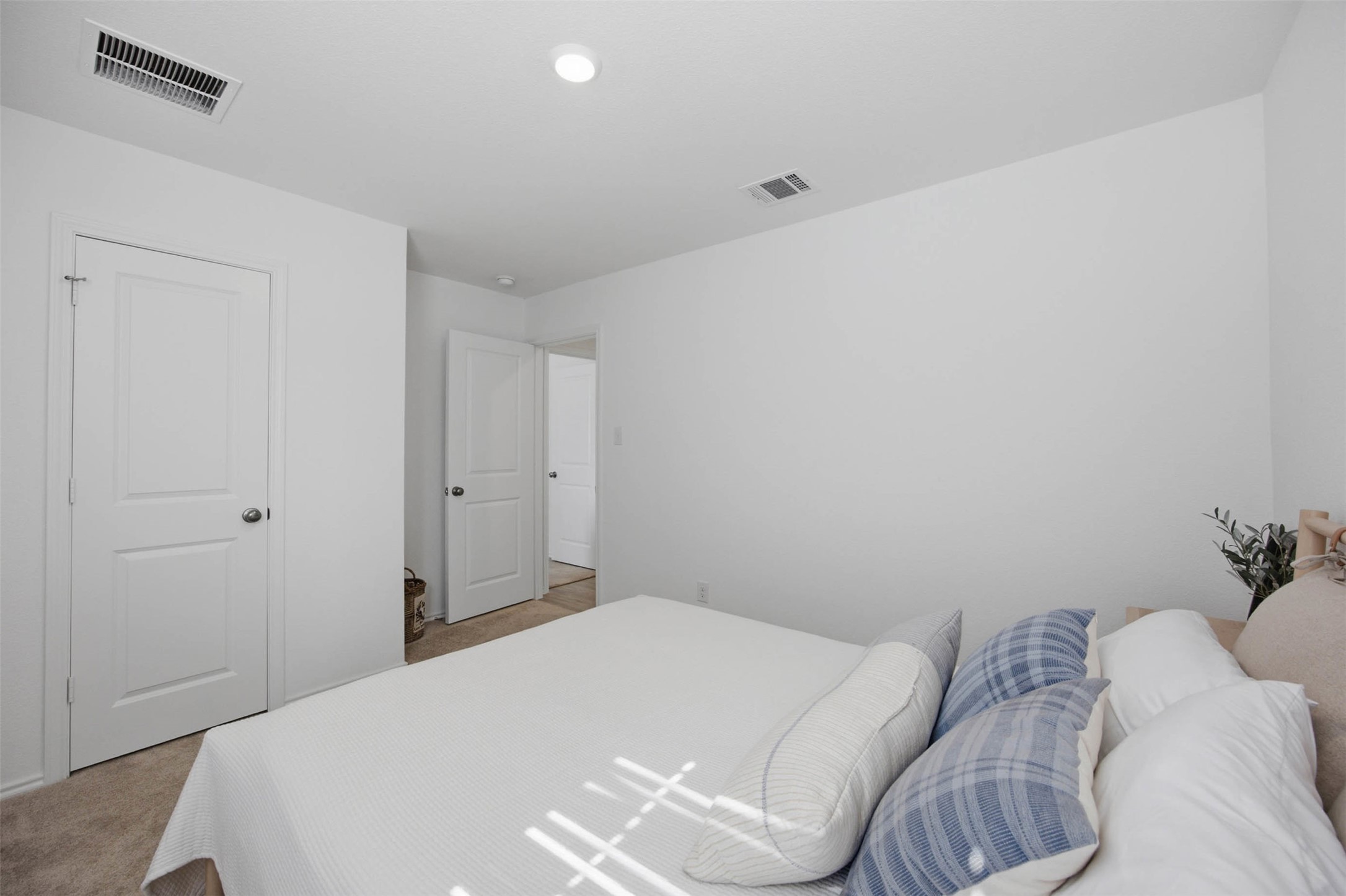171 Cattle Queen Road Jarrell, TX 76537 - Photo 18 of 38 Plush carpet flooring and clean minimalist walls create a tranquil bedroom retreat.