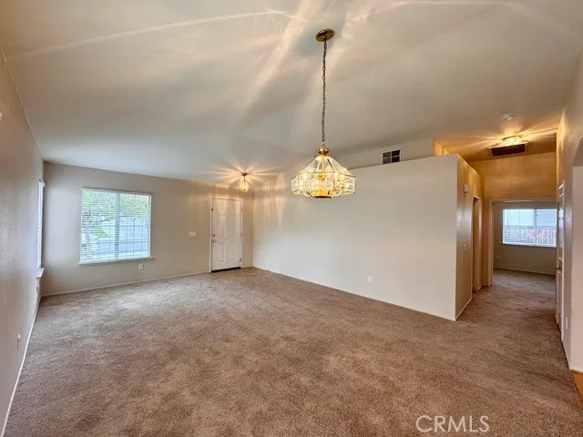 a view of a kitchen with a sink and dishwasher with wooden floor