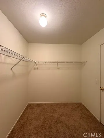 a bathroom with a granite countertop double vanity sink a mirror and a bathtub