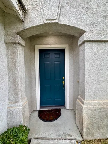 an empty room with windows and entrance