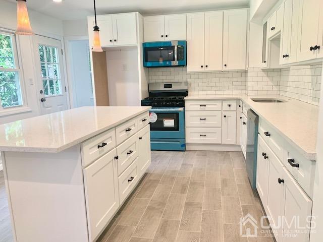 20 Sherwood Road Edison, NJ 08820 - Photo 11 of 26 a kitchen with white cabinets and appliances