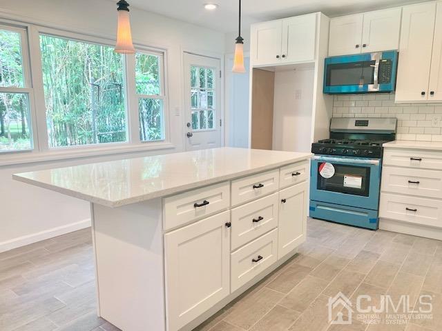 20 Sherwood Road Edison, NJ 08820 - Photo 12 of 26 a kitchen with stainless steel appliances granite countertop a stove a sink and a microwave