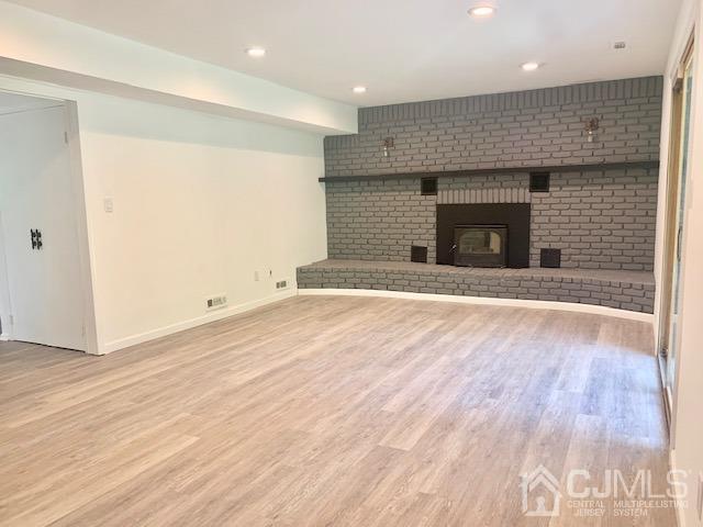 20 Sherwood Road Edison, NJ 08820 - Photo 15 of 26 an empty room with wooden floor and fireplace
