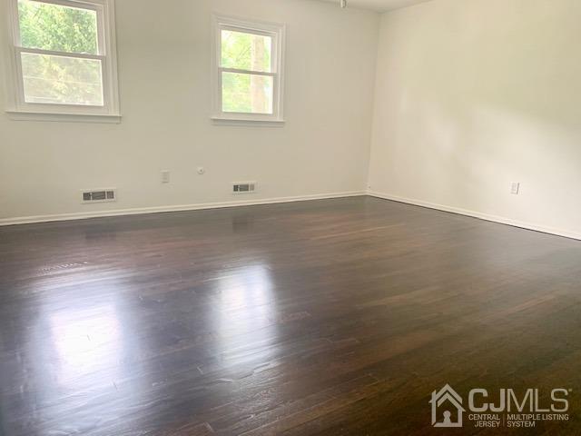 20 Sherwood Road Edison, NJ 08820 - Photo 20 of 26 an empty room with wooden floor and windows