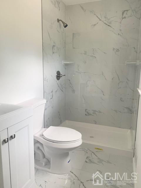 20 Sherwood Road Edison, NJ 08820 - Photo 21 of 26 a white toilet sitting next to a bath tub and a shower