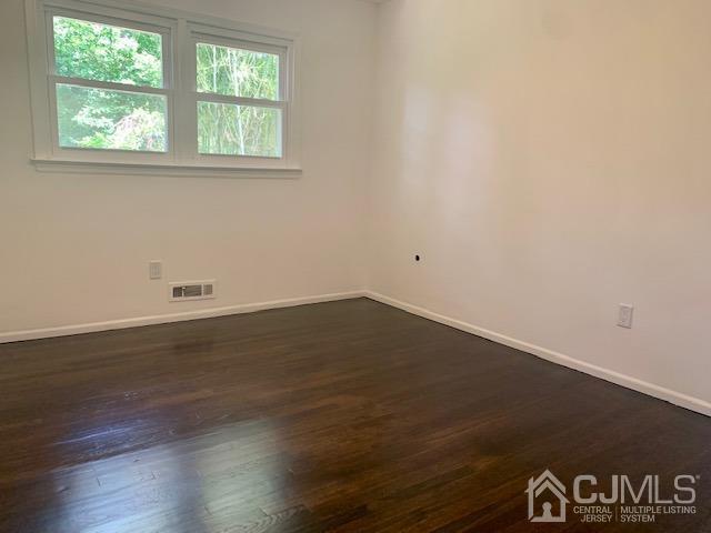 20 Sherwood Road Edison, NJ 08820 - Photo 22 of 26 an empty room with wooden floor and windows