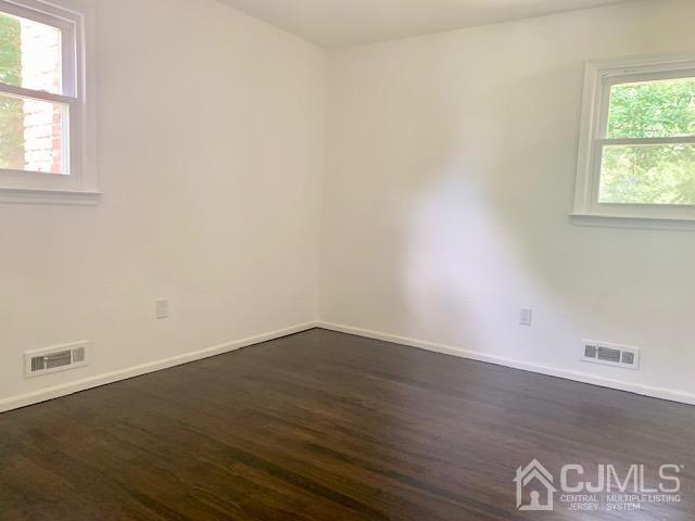 20 Sherwood Road Edison, NJ 08820 - Photo 24 of 26 an empty room with wooden floor and windows