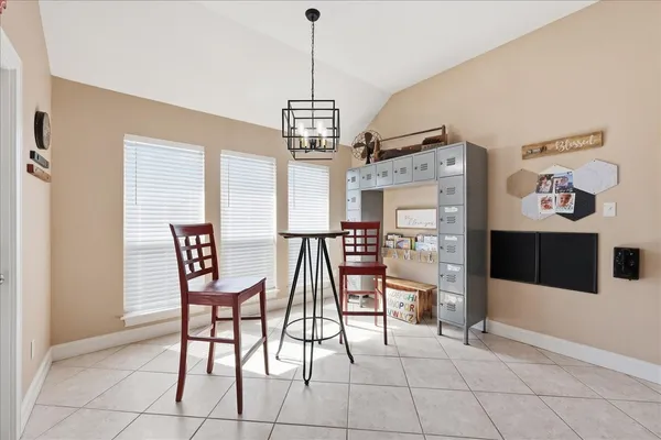 a view of a dining room with furniture and a chandelier