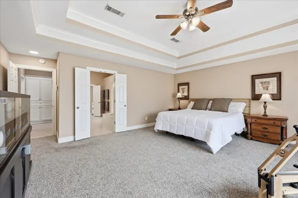 a spacious bathroom with a granite countertop sink mirror and bathtub