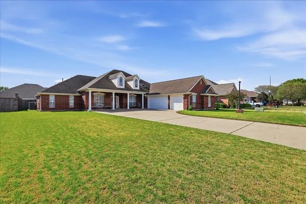 a front view of house with yard and green space