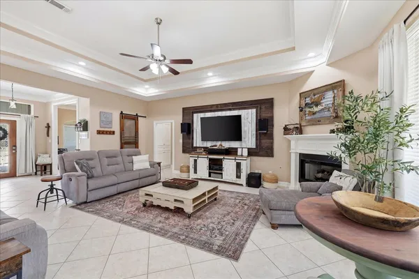 a living room with furniture a fireplace and a flat screen tv