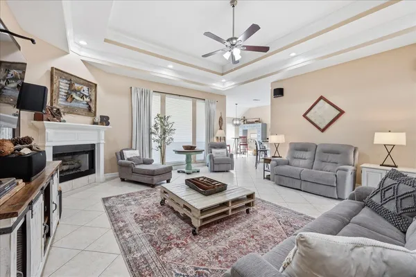 a living room with furniture a fireplace and a flat screen tv