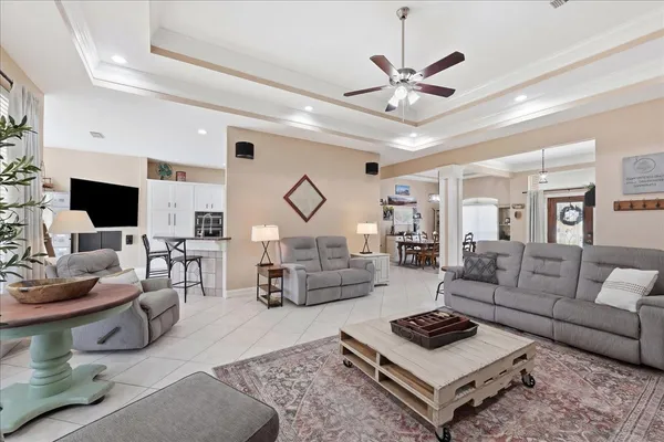 a living room with furniture a ceiling fan and a rug