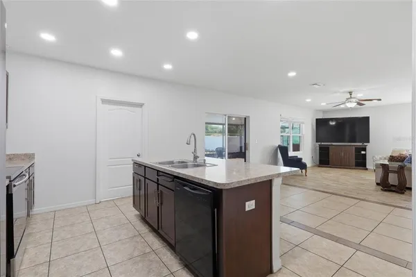 a kitchen with stainless steel appliances granite countertop a sink and stove