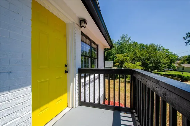 a view of balcony with wooden floor and fence