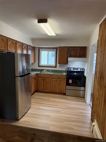 a kitchen with stainless steel appliances granite countertop a refrigerator and a stove