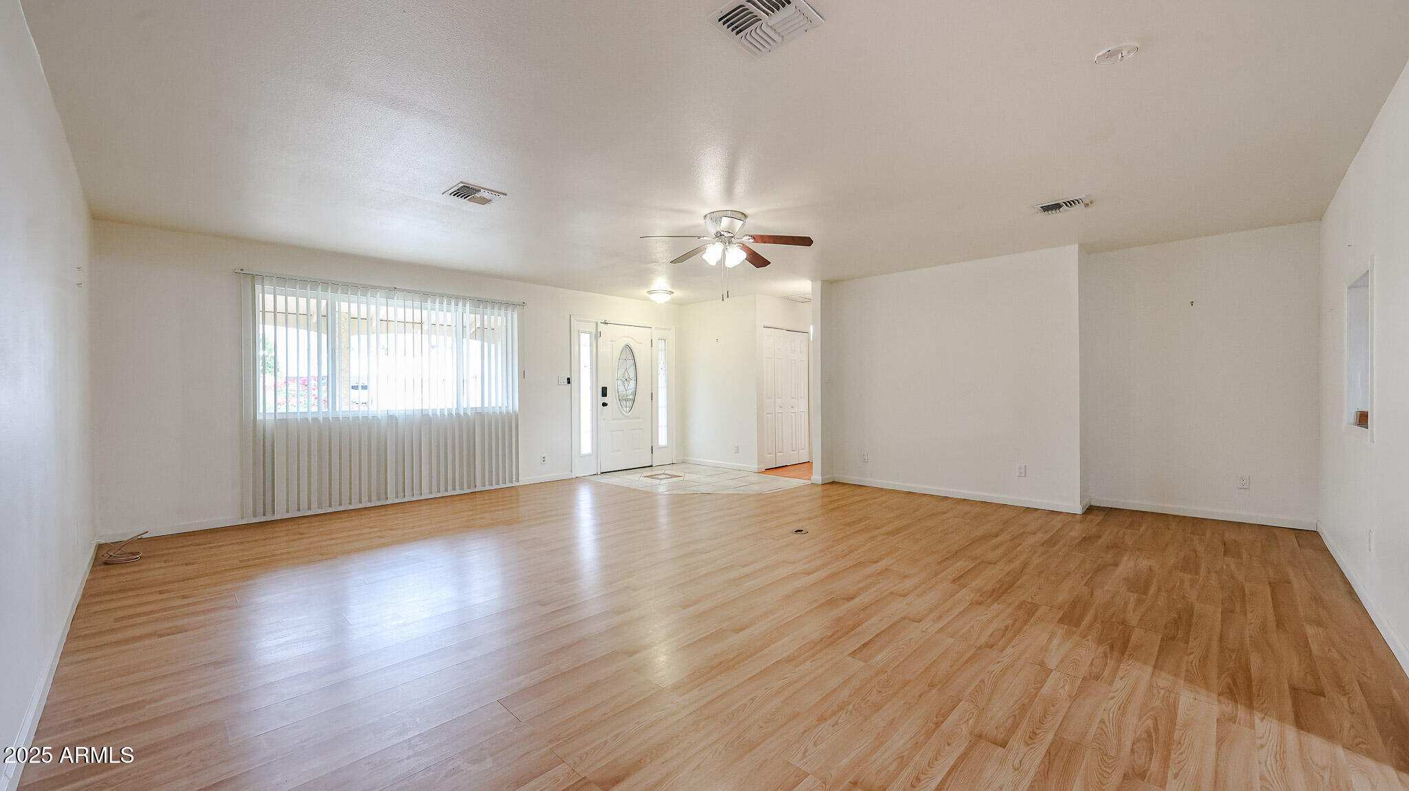 11851 North Thunderbird Road Sun City, AZ 85351 - Photo 8 of 46 a view of an empty room with wooden floor and a window