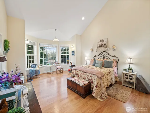 a bedroom with furniture and a large window