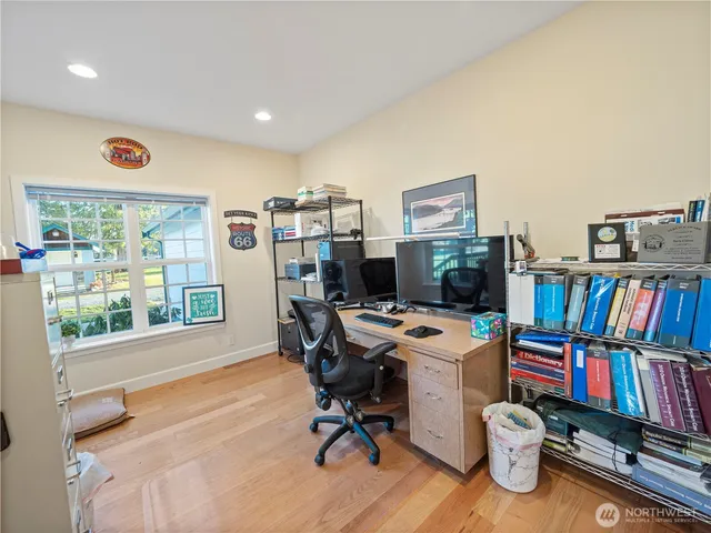 a view of a workspace with furniture and a bookshelf