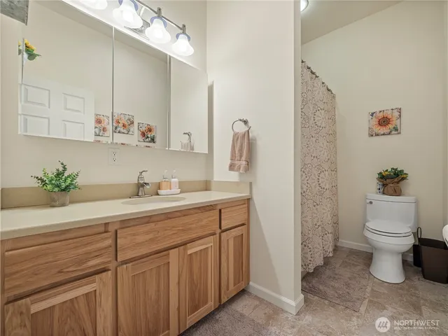 a bathroom with a sink a toilet and mirror
