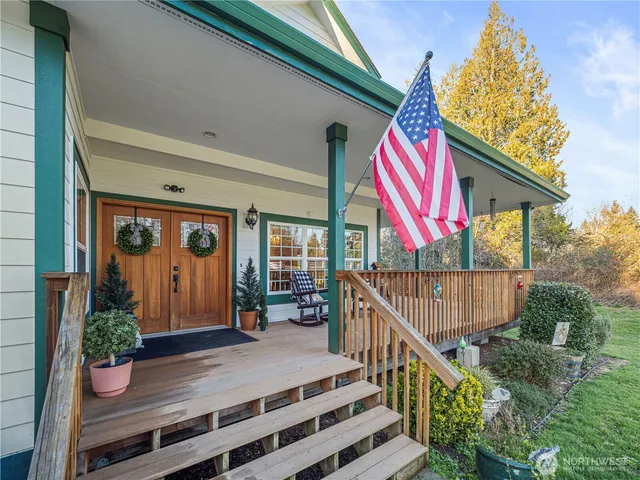 a front view of house with deck and outdoor seating