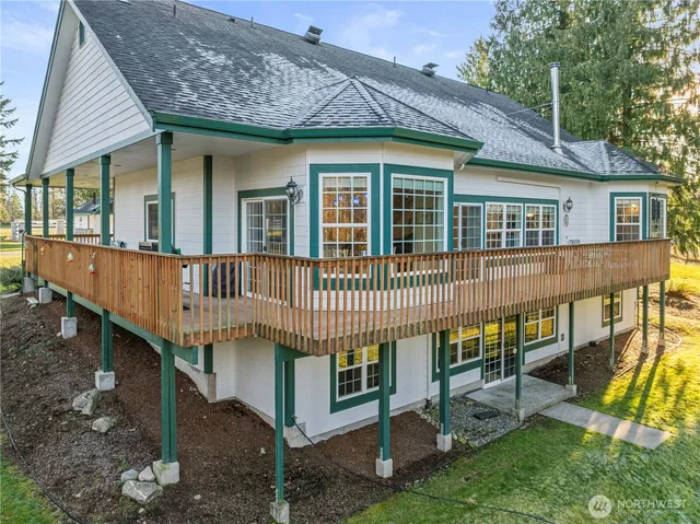 a view of a house with a yard and deck