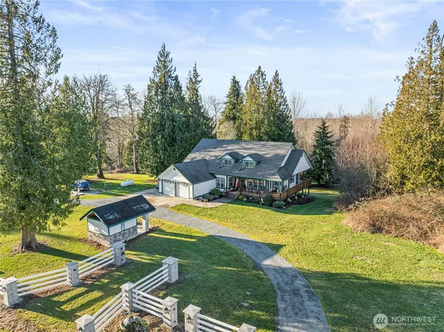 a view of a swimming pool with lawn chairs under an umbrella