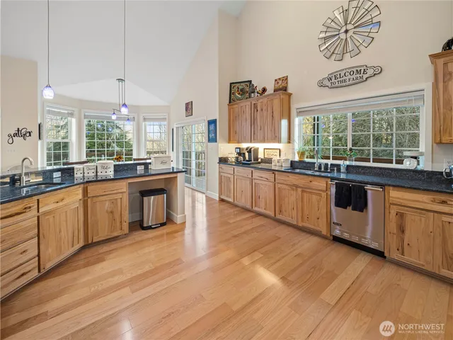 a large kitchen with stainless steel appliances granite countertop a stove and cabinets