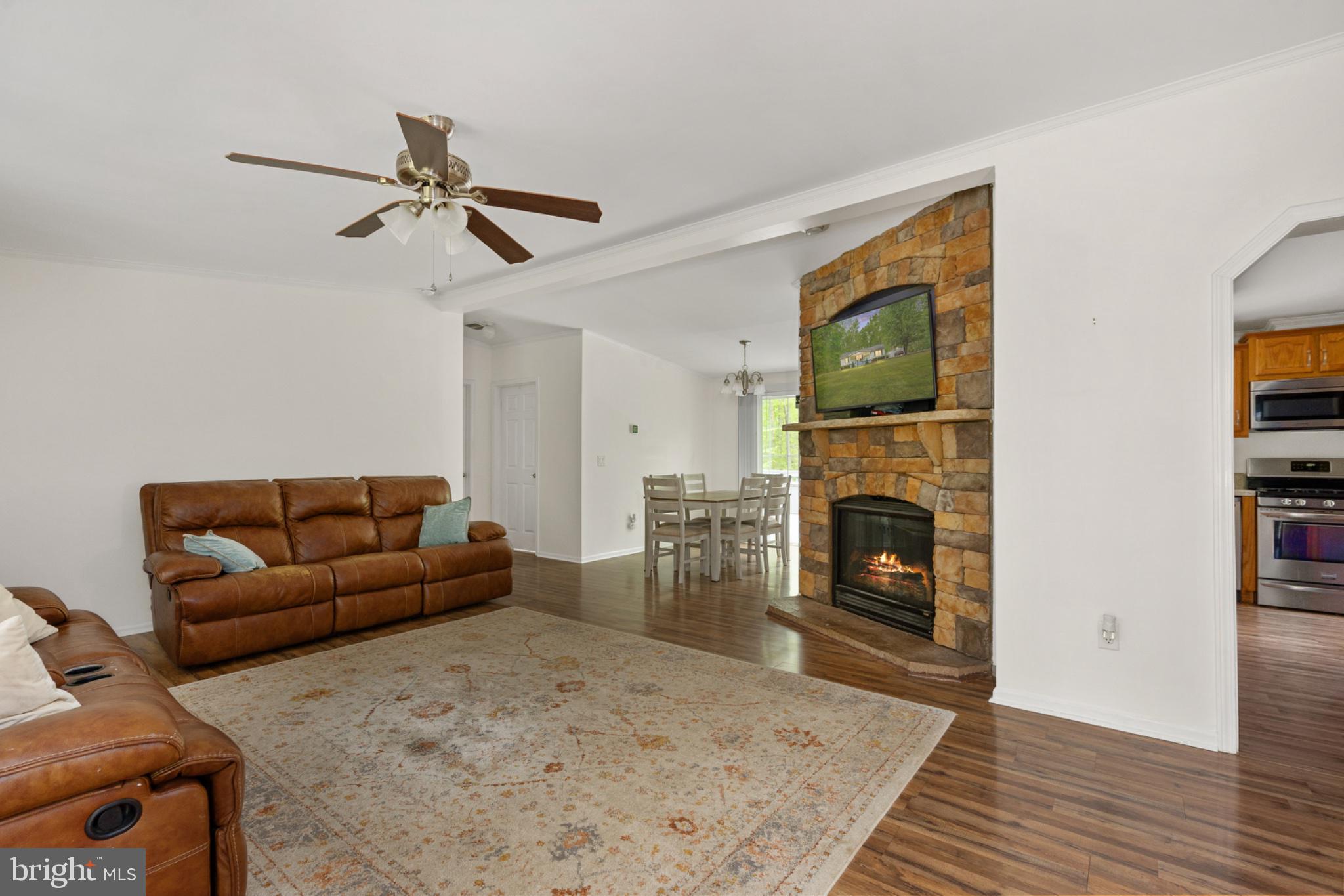 2319 Sizer Road Beaverdam, VA 23015 - Photo 40 of 61 a living room with furniture a flat screen tv and a fireplace