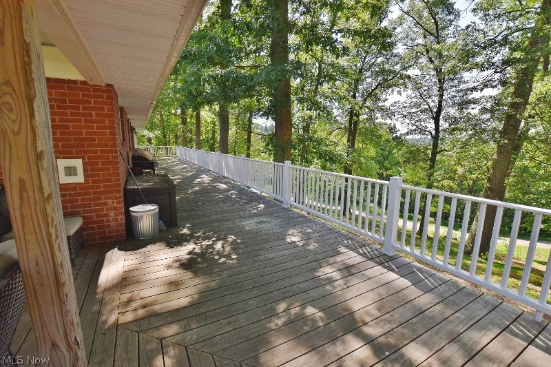 5007 Raven Road Southeast Carrollton, OH 44615 - Photo 9 of 50 The open part of the deck runs the entire length of the house.