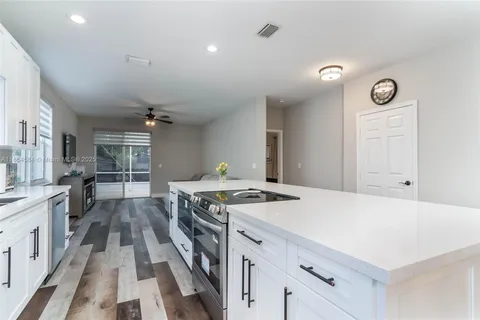 a kitchen that has a stove and a table in it