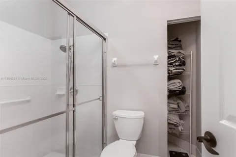 a bathroom with a toilet and a shower
