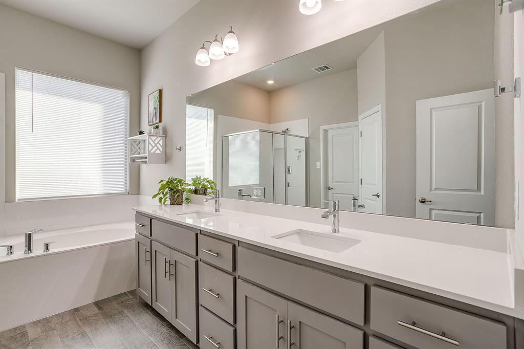 10108 Walnut Rdg Drive Grand Prairie, TX 76065 - Photo 11 of 21 a bathroom with a sink double vanity granite tub shower and a mirror