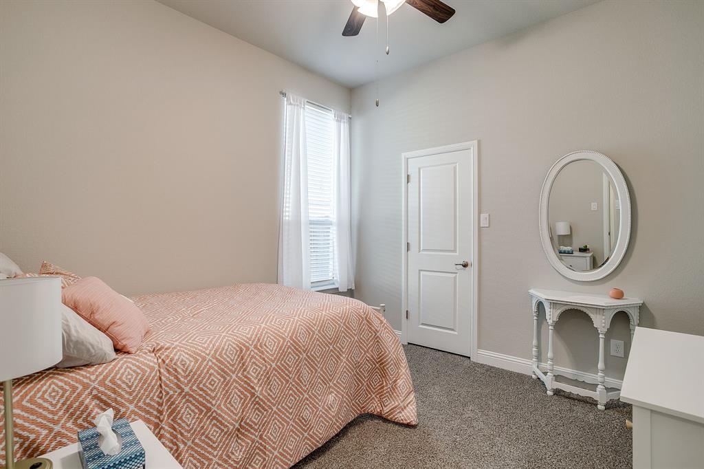 10108 Walnut Rdg Drive Grand Prairie, TX 76065 - Photo 13 of 21 a bedroom with a bed and a chandelier