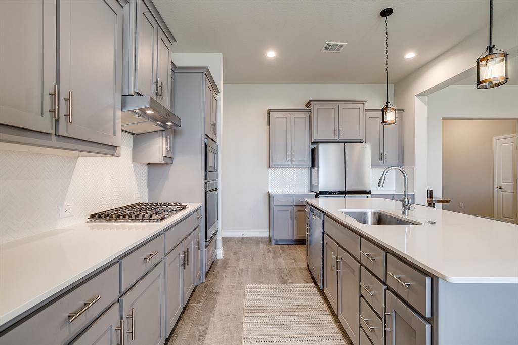 10108 Walnut Rdg Drive Grand Prairie, TX 76065 - Photo 6 of 21 a kitchen with stainless steel appliances granite countertop a sink stove and cabinets