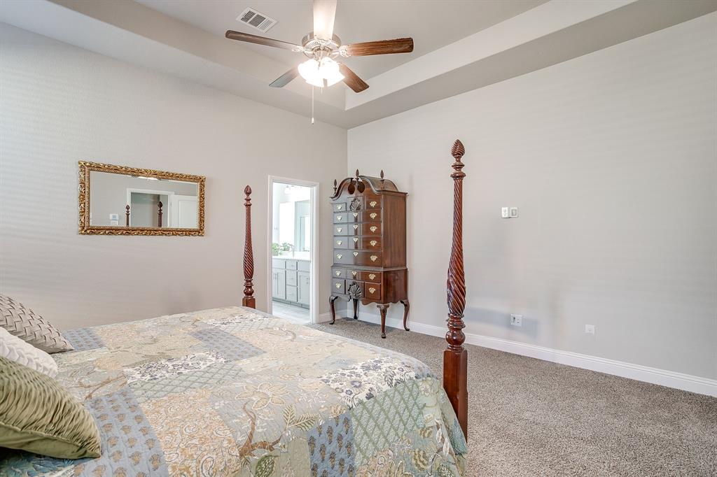 10108 Walnut Rdg Drive Grand Prairie, TX 76065 - Photo 10 of 21 a bedroom with a large bed and a chandelier
