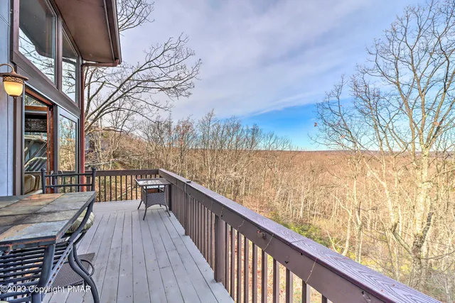 a view of a balcony with wooden floor and fence
