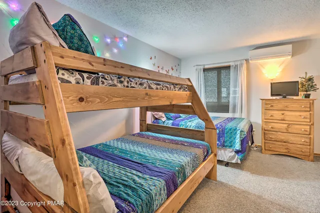 a bedroom with a bed and a baby crib