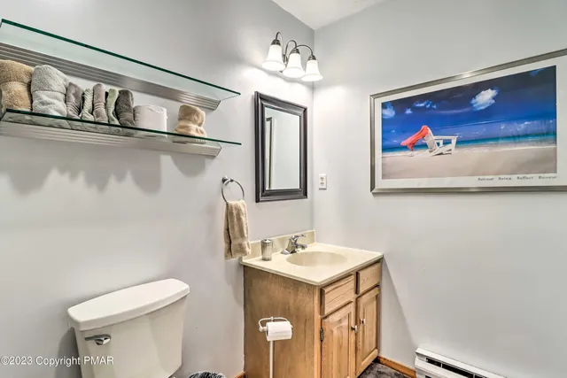 a bathroom with a toilet a sink and mirror
